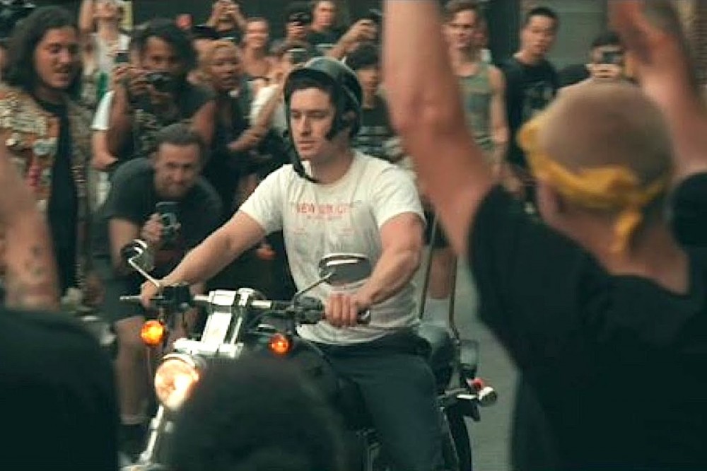 Concertgoer on Motorcycle Cruises Into Mosh Pit at Outdoor Punk Show Concertgoer on Motorcycle Cruises Into Mosh Pit at Outdoor Punk Show