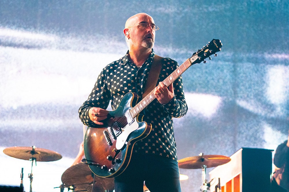 Oasis + Liam Gallagher Guitarist Paul ‘Bonehead’ Arthurs Diagnosed With Tonsil Cancer
