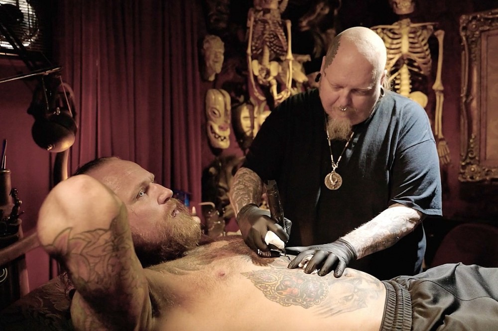AEW’s Malakai Black Talks Mental Health + WWE vs. AEW While Getting Tattooed by Paul Booth AEW’s Malakai Black Talks Mental Health + WWE vs. AEW While Getting Tattooed by Paul Booth